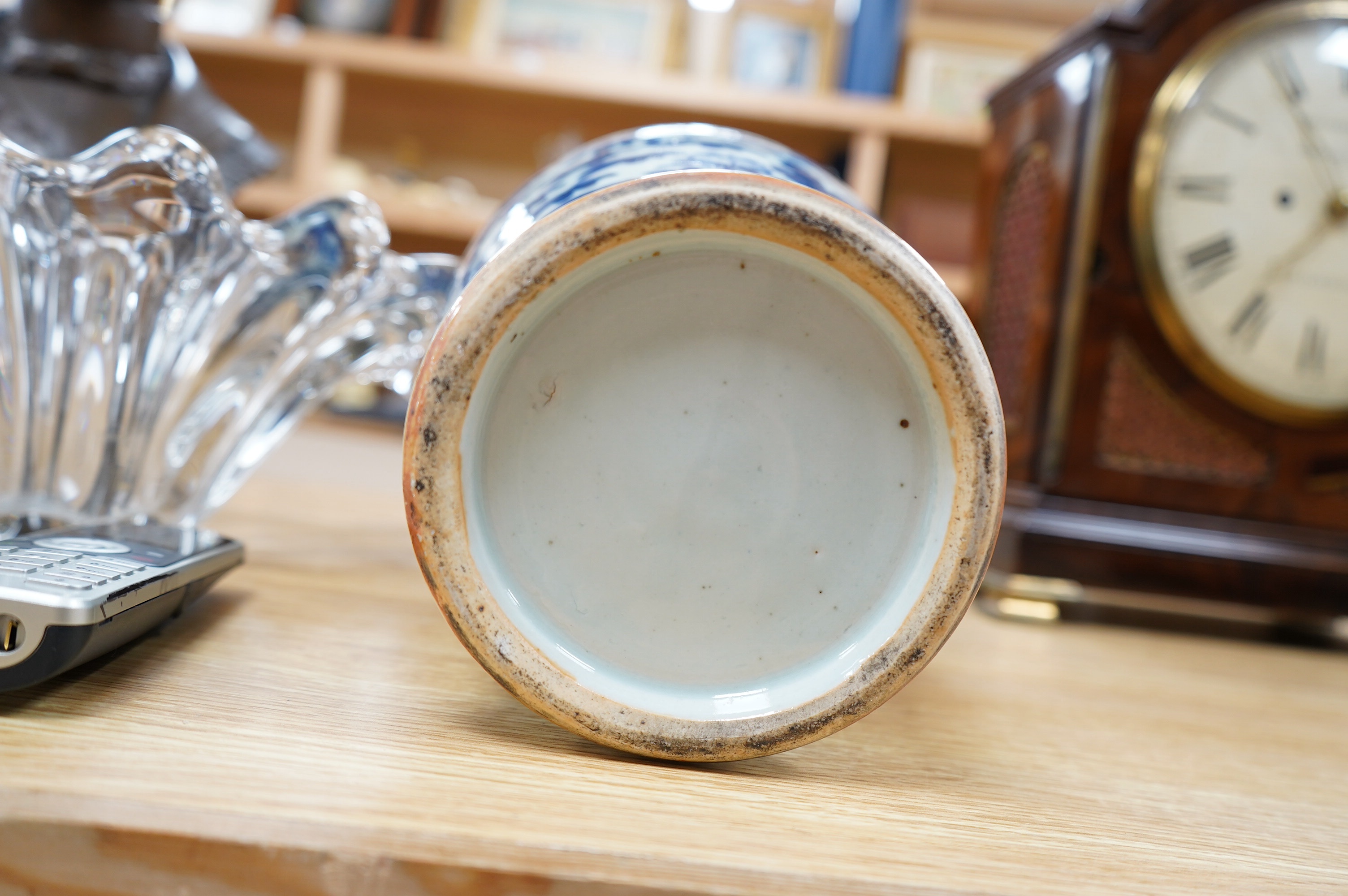 An early 20th century Chinese blue and white dragon vase and cover, 42cm high. Condition - crack and chip from rim of vase down the neck